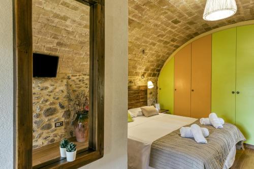 a bedroom with a bed with towels on it at Can Cortada in Cantallops