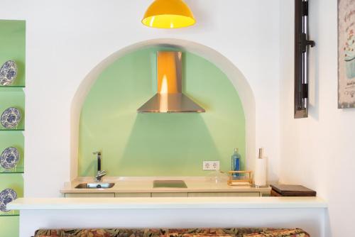 a kitchen with a sink and a light fixture at Apartamento Geranio in Vejer de la Frontera