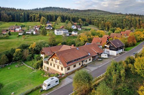an aerial view of a large house with a van parked on the street at Haus Löwen in Forbach