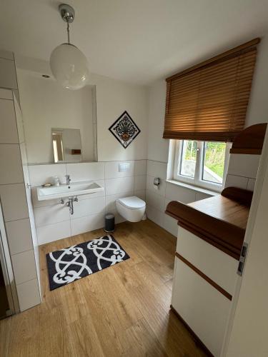 a small bathroom with a sink and a toilet at Hofberg Villa - Appartment in Landshut