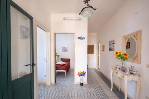 a hallway with a door leading to a living room at Malva House in Villa Con Piscina in Torre Lapillo