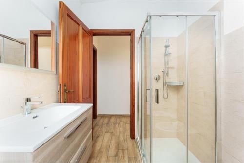 a bathroom with a sink and a shower at Cozy And Cool Flat in Orosei