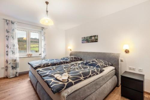 a bedroom with a bed and a couch at Ferienwohnung Ruhrtal in Bestwig