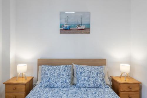 a bedroom with a bed with two night stands and two lamps at Brisa de mar in Puerto Naos