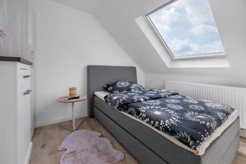 a bedroom with a bed and a skylight at Ferienwohnung 2 in Bad Salzuflen