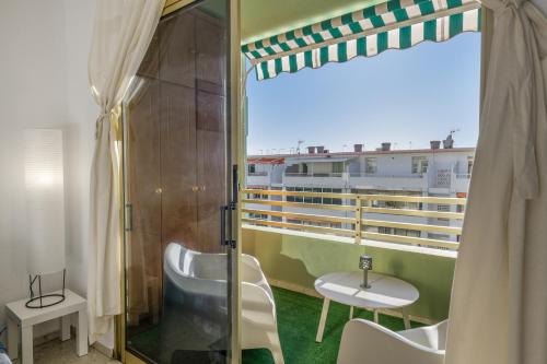 a balcony on a cruise ship with a table and chairs at Brisa de mar in Puerto Naos