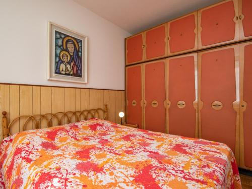 a bedroom with a bed with a colorful bedspread at Casa Camilla in Manerba del Garda