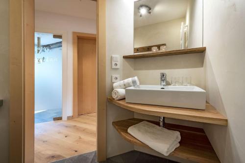 a bathroom with a sink and a mirror at Bergblick App Fichte in Villnoss