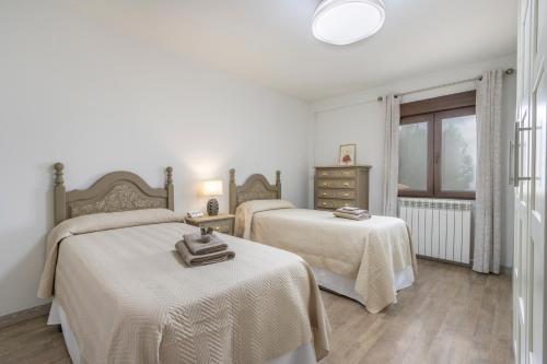 a bedroom with two beds and a window at El Cierzo de Sediles in Sediles