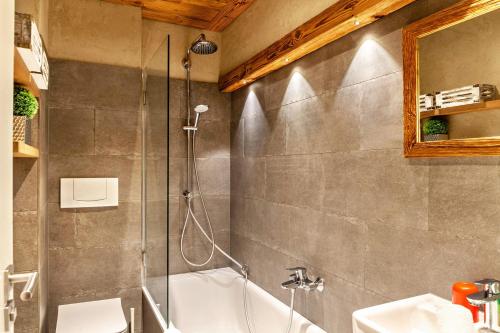 a bathroom with a shower and a tub and a sink at Haus Excelsior Top 36 in Seefeld in Tirol