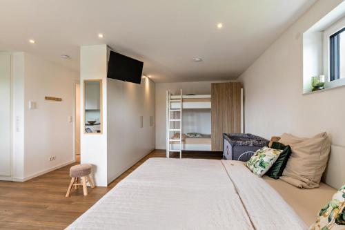 a bedroom with a large bed and a couch at Fewo Parkside S3 - 8Min Legoland in Günzburg