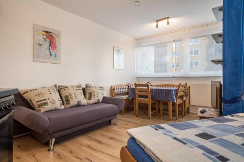 a living room with a couch and a table and chairs at Ferienwohnung Förster in Überlingen