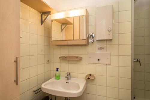 a bathroom with a sink and a mirror at Ferienwohnung Förster in Überlingen