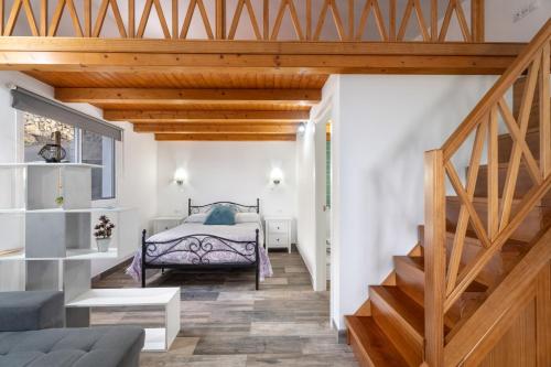 a bedroom with a bed and a staircase at Loft de Tato in Frontera