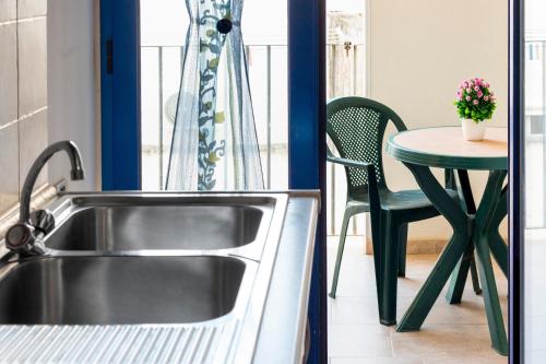 a kitchen with a sink and a table at Dimora Giusy in Otranto