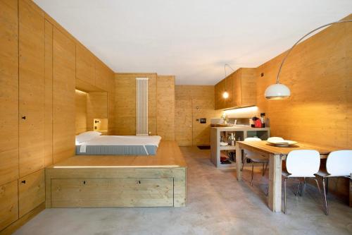 a bedroom with a bed and a table and chairs at Secret Place - Pila Appartamenti in Pila