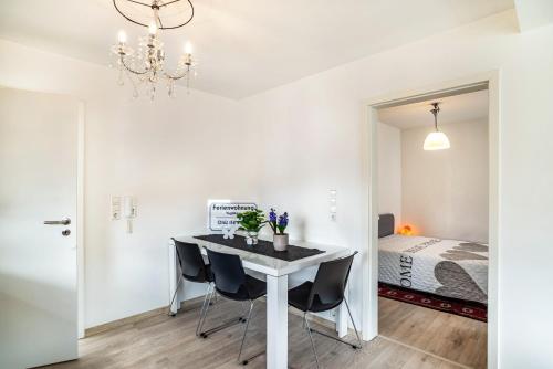 a dining room with a table and chairs and a bed at Vogtshaus in Gernsbach