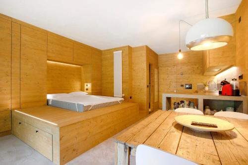 a bedroom with a bed and a wooden table at Secret Place - Pila Appartamenti in Pila