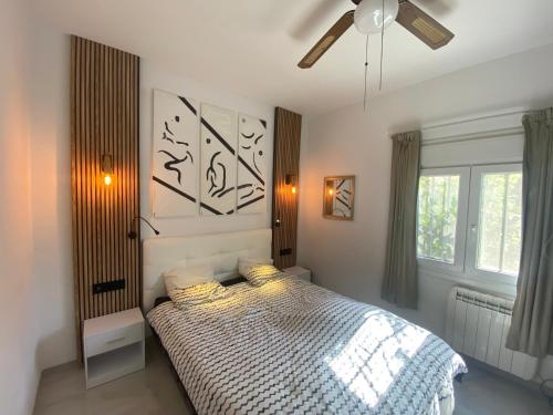 a bedroom with a bed and a ceiling fan at Las fuentes in Alcossebre