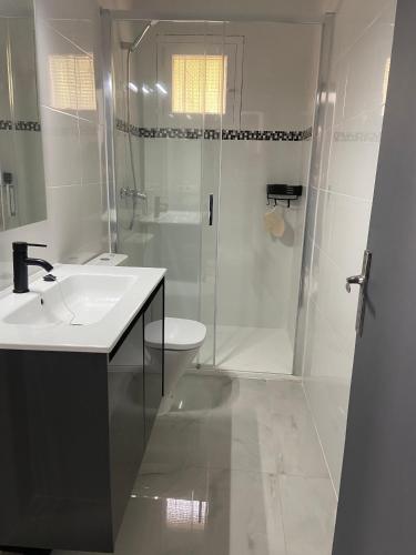 a bathroom with a shower and a sink and a toilet at Las fuentes in Alcossebre