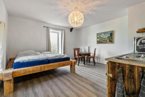 a bedroom with a bed and a dining room at Gutgemacht in Sankt Annen