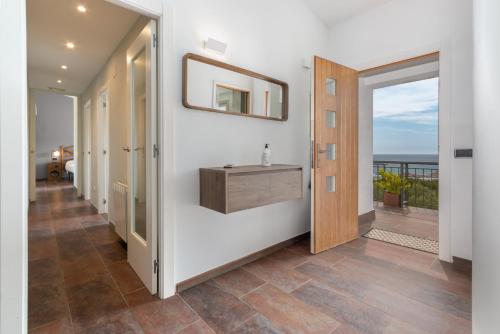 a hallway with a vanity and a view of the ocean at Espectacular villa en Begur in Begur