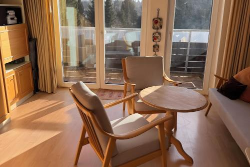 a living room with two chairs and a table at Wurmbergzauber Sonnenschein in Braunlage