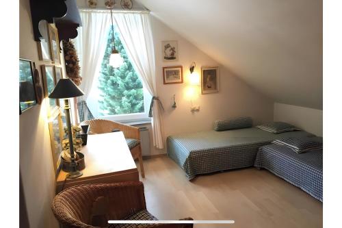 a bedroom with a bed and a desk and a window at Wurmbergzauber Sonnenschein in Braunlage