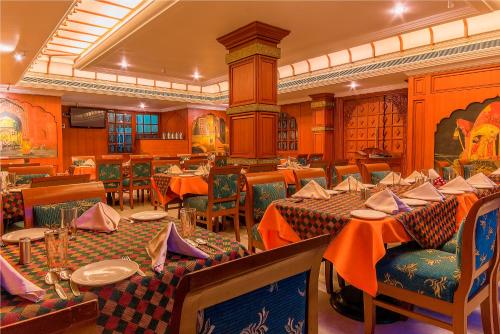 a restaurant with tables and chairs in a room at Hotel Annamalai International in Puducherry
