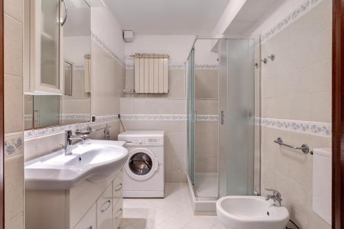 a bathroom with a sink and a washing machine at Il Faro in Celle Ligure