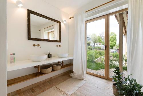 a bathroom with two sinks and a large window at Im Gräbele in Rosenfeld
