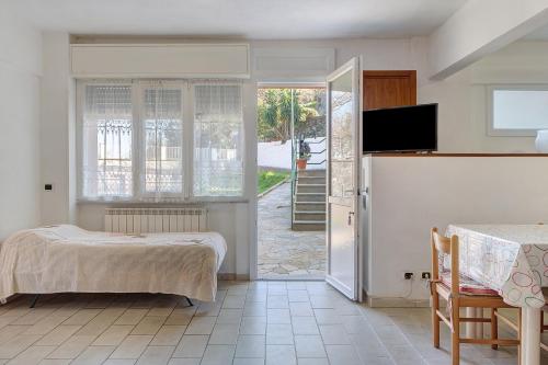a bedroom with a bed and a sliding glass door at Il Faro in Celle Ligure