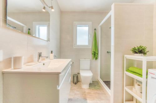 a bathroom with a sink and a toilet and a shower at White Sands 306 in Arenal d'en Castell