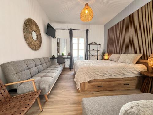 a living room with two beds and a couch at aeolian blu 4 in Parikia