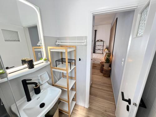 a bathroom with a sink and a mirror at aeolian blu 4 in Parikia
