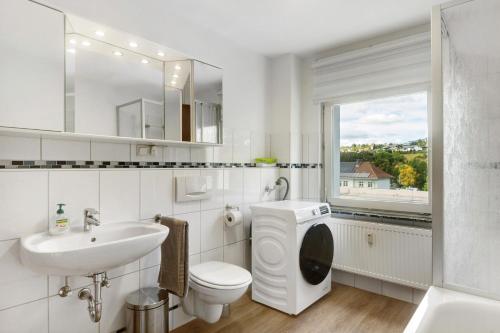 a white bathroom with a sink and a toilet at Fewo Schneider Bad Wildungen in Bad Wildungen