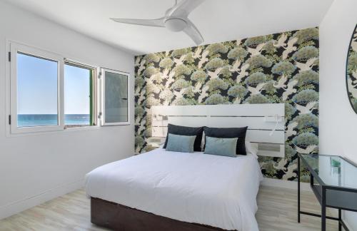 a bedroom with a bed and two windows at 51 Avenue Playa Honda in Playa Honda