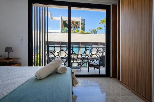 a bedroom with a bed with a view of a balcony at Luxury Penthouse with Ocean Views and Private Pool in Playa del Carmen