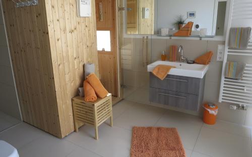 a small bathroom with a sink and a mirror at Ferienhaus Olpenitz und Strand in Kappeln