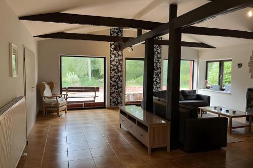 a living room with a couch and a table at Ferienhaus Vossberg in Grabow