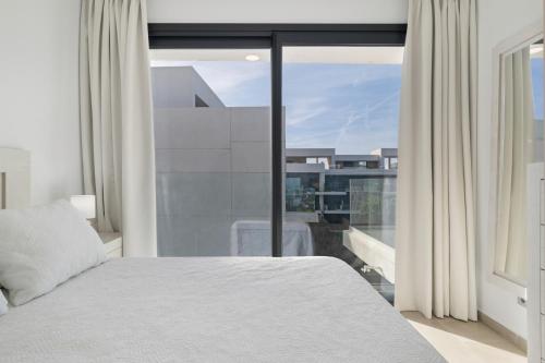 a bedroom with a bed and a large window at Casa África in Zahara de los Atunes