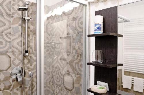 a bathroom with a shower with a glass door at Botafogo in Chiavari