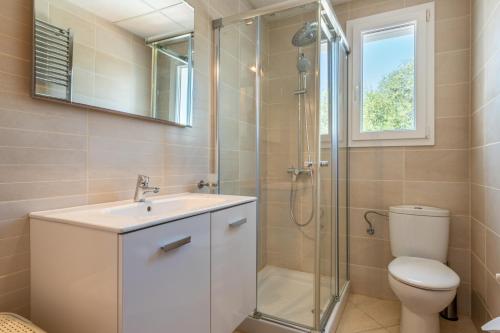 a bathroom with a toilet and a sink and a shower at Villa Luca in Cala d´Or
