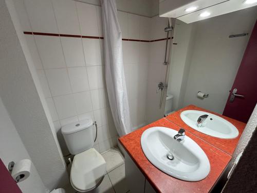 a bathroom with a sink and a toilet at L'Izard Piscine, Jacuzzi, Parking in Cauterets