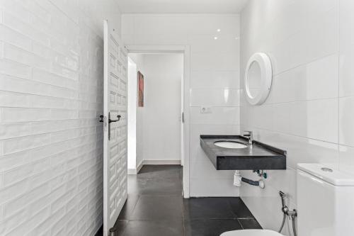 a white bathroom with a sink and a toilet at Casa Green in Mijas Costa