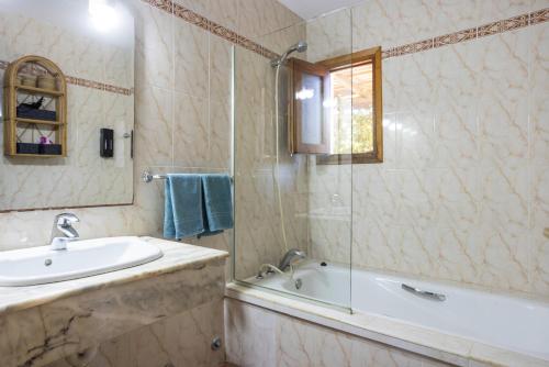 a bathroom with a tub and a sink and a bath tub at Can Mussenya 2 in Illes Balears