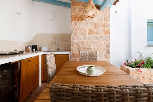 a kitchen with a wooden table with a bowl on it at Casa Le Rocce San Pantaleo in San Pantaleo