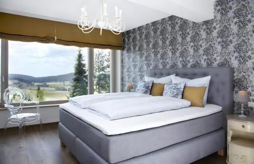 a bedroom with a large bed and a window at Panorama Atemlos Kuckucks Chillout in Oberibach