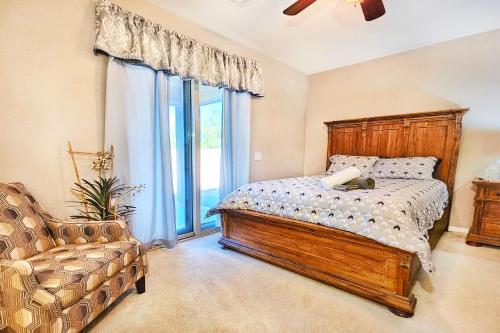 a bedroom with a bed and a chair and a window at Spacious Desert Suite Minutes to Phoenix Fun - Pet Friendly! in Avondale
