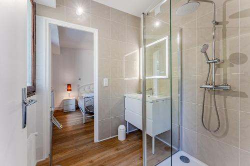 a bathroom with a shower and a sink at Appartement Rose Mousse - Abatilles in Arcachon